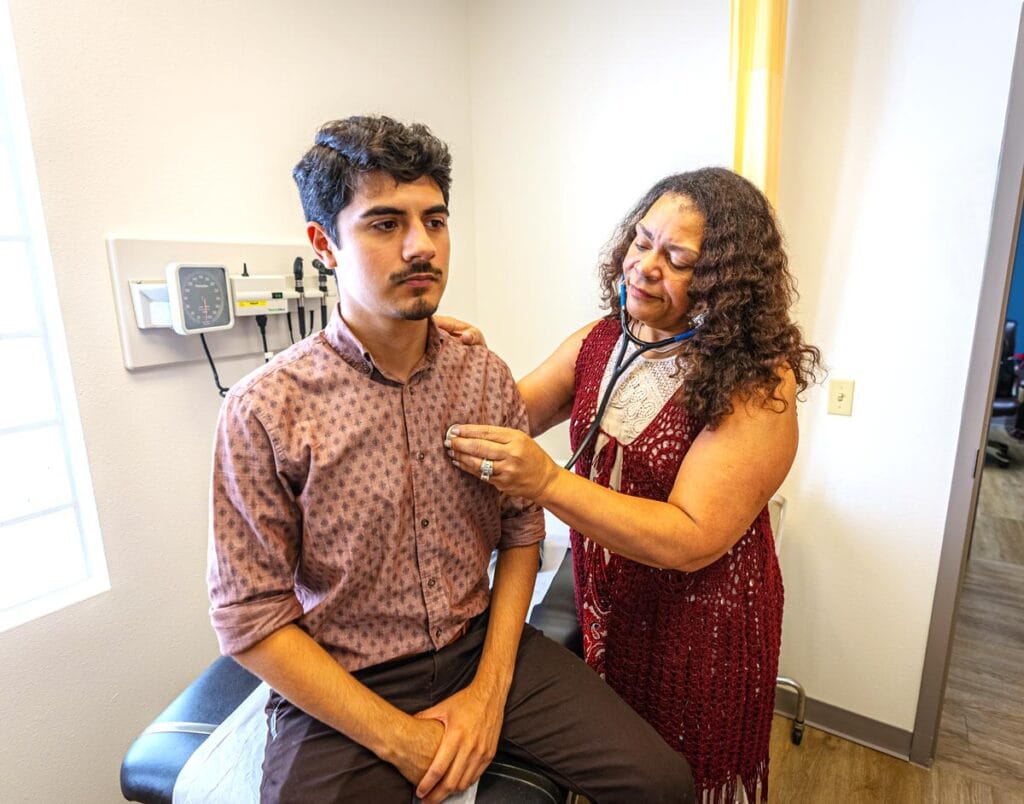 Male patient is receiving a heart health check during an appointment with a female nurse.