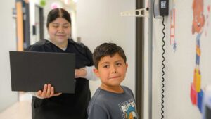 nurse with pediatric patient for wellness visit and back to school checkup at healthcare clinic in texas