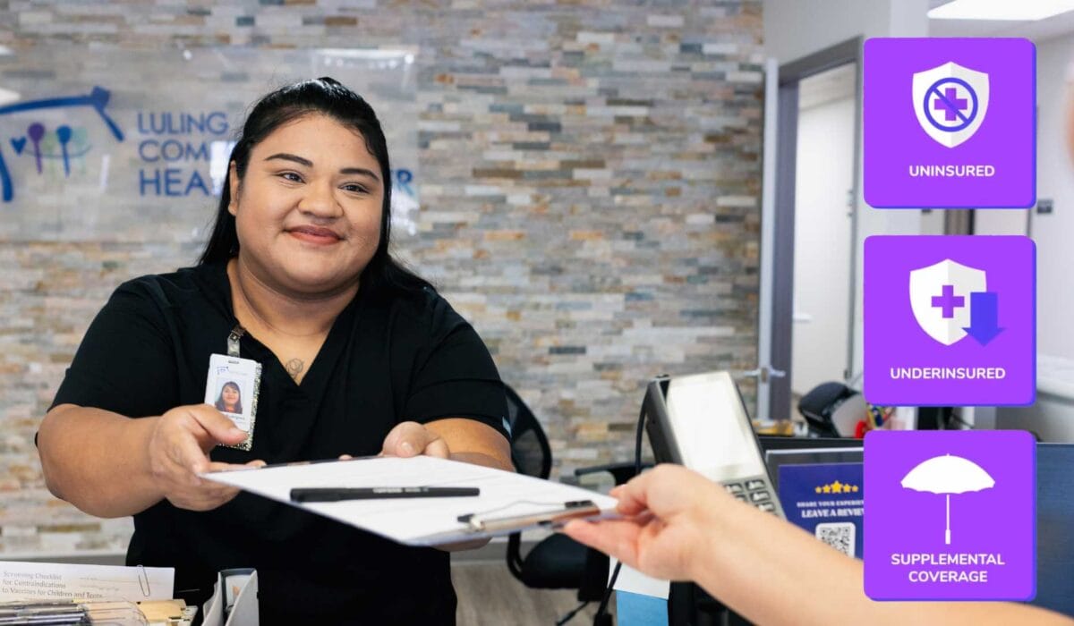 Eligibility Services and front desk check in staff handing paperwork