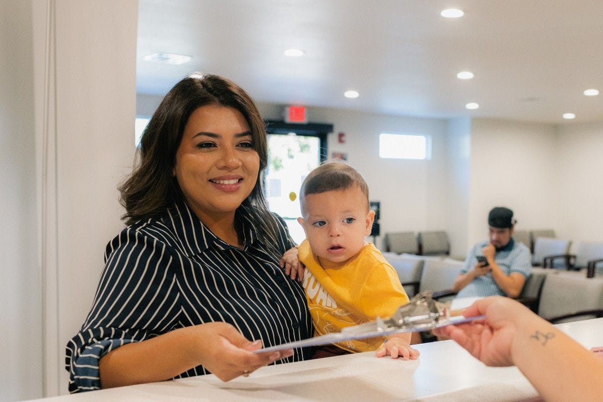 Mother and Pediatric Patient Baby at Front Desk