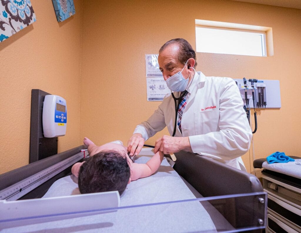 Jose Castaneda with pediatric patient baby