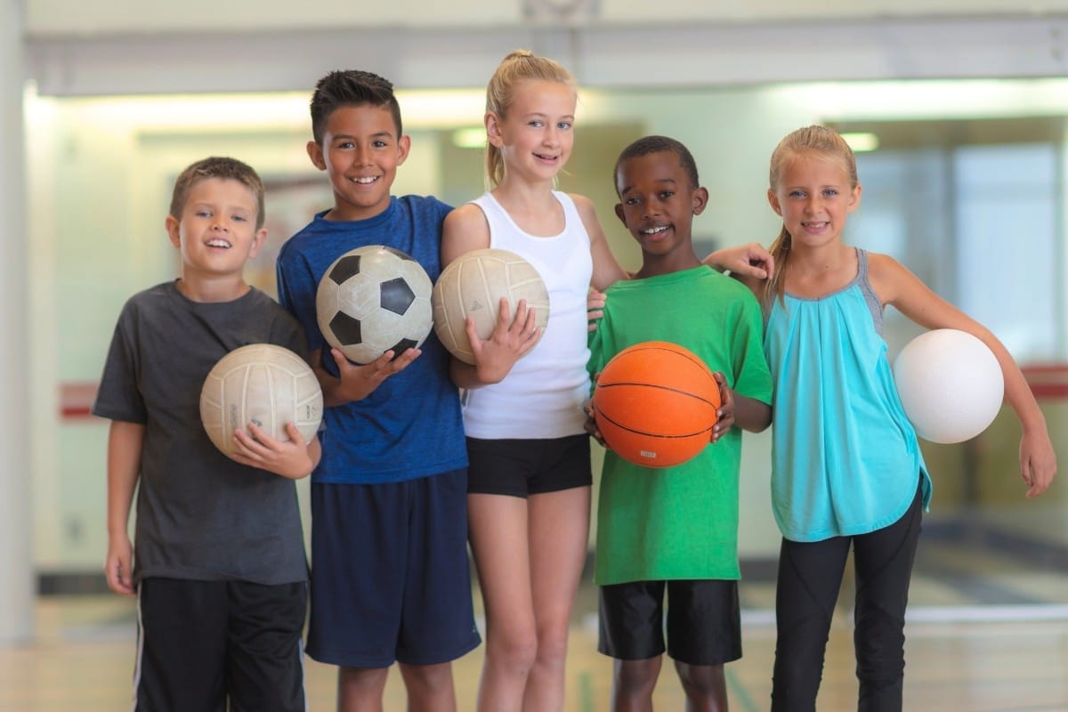 Kids holding sports equipment
