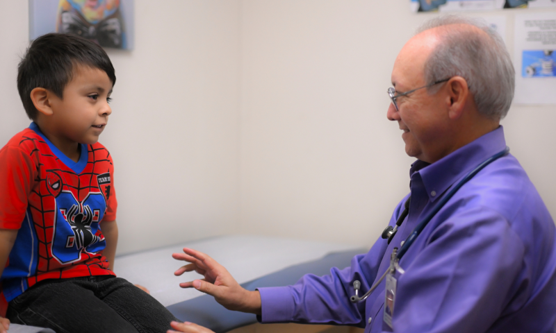 Elgin Health Center Dr. Larry Herrera with Pediatric Patient