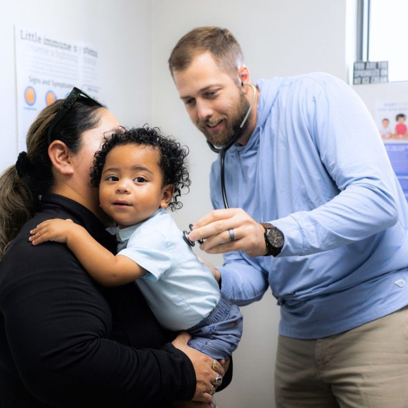 Pediatrician with a Cute Baby Patient for Pediatric Services, Well Visits, and Sick Visit